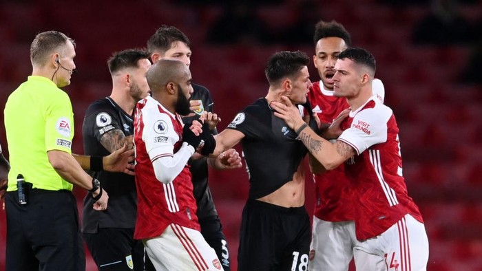 LONDON, ENGLAND - DECEMBER 13: Granit Xhaka of Arsenal grabs Ashley Westwood of Burnley round the throat and is subsequently shown a red card and sent off after a VAR check during the Premier League match between Arsenal and Burnley at Emirates Stadium on December 13, 2020 in London, England. A limited number of spectators (2000) are welcomed back to stadiums to watch elite football across England. This was following easing of restrictions on spectators in tiers one and two areas only. (Photo by Laurence Griffiths/Getty Images)