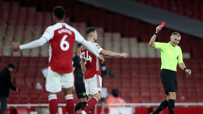 LONDON, ENGLAND - DECEMBER 13: Granit Xhaka of Arsenal is shown a red card by match referee Graham Scott during the Premier League match between Arsenal and Burnley at Emirates Stadium on December 13, 2020 in London, England. A limited number of spectators (2000) are welcomed back to stadiums to watch elite football across England. This was following easing of restrictions on spectators in tiers one and two areas only. (Photo by Nick Potts - Pool/Getty Images)