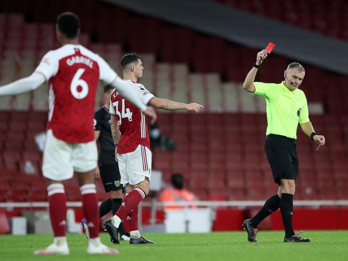 LONDON, ENGLAND - DECEMBER 13: Granit Xhaka of Arsenal is shown a red card by match referee Graham Scott during the Premier League match between Arsenal and Burnley at Emirates Stadium on December 13, 2020 in London, England. A limited number of spectators (2000) are welcomed back to stadiums to watch elite football across England. This was following easing of restrictions on spectators in tiers one and two areas only. (Photo by Nick Potts - Pool/Getty Images)