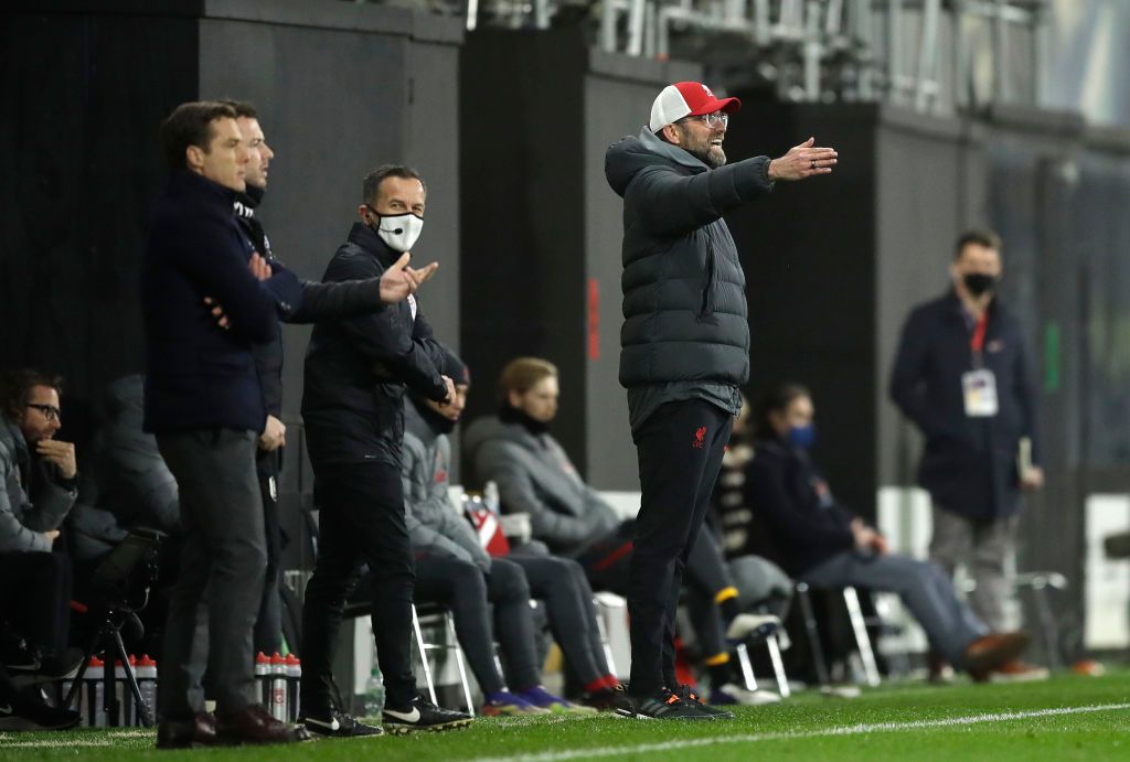 LONDON, ENGLAND - DECEMBER 13: Jurgen Klopp, Manager of Liverpool  gives their team instructions as Scott Parker, Manager of Fulham looks on during the Premier League match between Fulham and Liverpool at Craven Cottage on December 13, 2020 in London, England. A limited number of spectators (2000) are welcomed back to stadiums to watch elite football across England. This was following easing of restrictions on spectators in tiers one and two areas only. (Photo by Mike Hewitt/Getty Images)