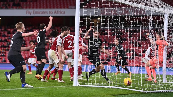 LONDON, ENGLAND - DECEMBER 13: (L-R) Ben Mee, Ashley Barnes and James Tarkowski of Burnley celebrate as Pierre-Emerick Aubameyang of Arsenal (obstructed) scores an own goal during the Premier League match between Arsenal and Burnley at Emirates Stadium on December 13, 2020 in London, England. A limited number of spectators (2000) are welcomed back to stadiums to watch elite football across England. This was following easing of restrictions on spectators in tiers one and two areas only. (Photo by Laurence Griffiths/Getty Images)