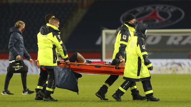 PSG's Neymar, center, is carried off the field on a stretcher after getting injured during the League One soccer match between Paris Saint Germain and Lyon, at the Parc des Princes stadium in Paris, France, Sunday, Dec. 13, 2020. (AP Photo/Thibault Camus)