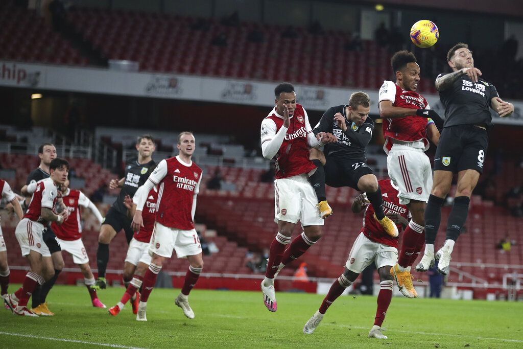 The ball skims off the head of Arsenal's Pierre-Emerick Aubameyang, 2nd right for an own-goal during an English Premier League soccer match between Arsenal and Burnley at the Emirates stadium in London, England, Sunday Dec. 13, 2020. (Nick Potts/Pool via AP)
