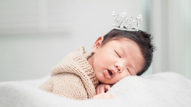 Cute baby boy with beautiful blue eyes on the white background