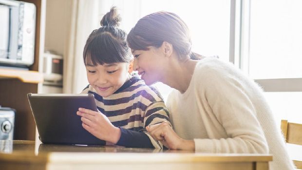 Girl using a digital tablet in home