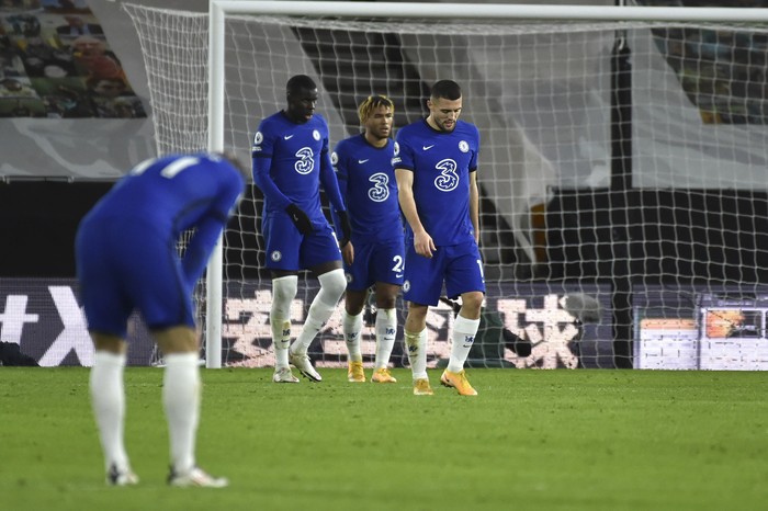 Chelsea players react after Wolverhampton Wanderers Pedro Neto scores during the English Premier League soccer match between Wolverhampton Wanderers and Chelsea at the Molineux Stadium in Wolverhampton, England, Tuesday, Dec. 15, 2020. (AP Photo/Rui Vieira, Pool)