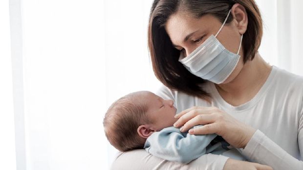 Soft focus of happy mother with newborn baby