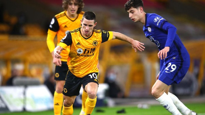 WOLVERHAMPTON, ENGLAND - DECEMBER 15: Daniel Podence of Wolves is challenged by Kai Havertz of Chelsea during the Premier League match between Wolverhampton Wanderers and Chelsea at Molineux on December 15, 2020 in Wolverhampton, England. The match will be played without fans, behind closed doors as a Covid-19 precaution. (Photo by Michael Steele/Getty Images)