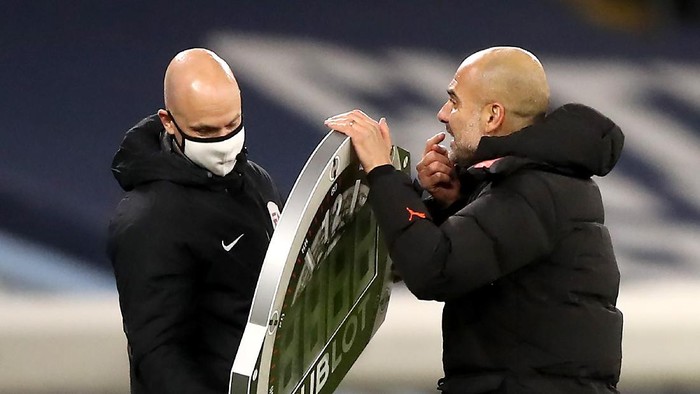 MANCHESTER, ENGLAND - DECEMBER 15: Pep Guardiola, Manager of Manchester City argues with fourth official Anthony Taylor during the Premier League match between Manchester City and West Bromwich Albion at Etihad Stadium on December 15, 2020 in Manchester, England. The match will be played without fans, behind closed doors as a Covid-19 precaution.  (Photo by Martin Rickett - Pool/Getty Images)