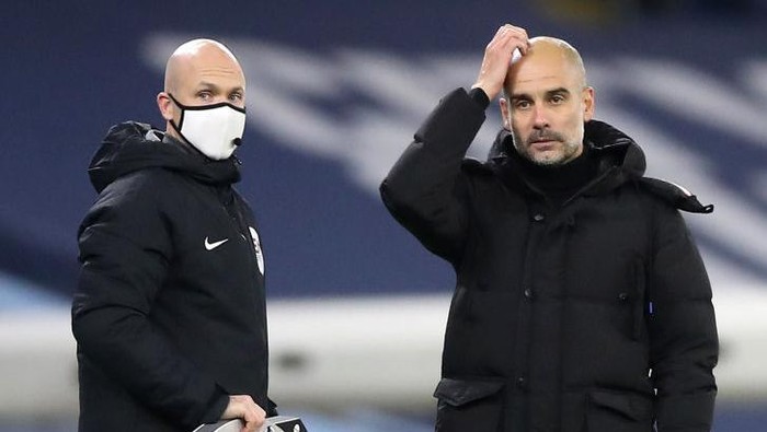 MANCHESTER, ENGLAND - DECEMBER 15: Pep Guardiola, Manager of Manchester City argues with fourth official Anthony Taylor during the Premier League match between Manchester City and West Bromwich Albion at Etihad Stadium on December 15, 2020 in Manchester, England. The match will be played without fans, behind closed doors as a Covid-19 precaution.  (Photo by Martin Rickett - Pool/Getty Images)