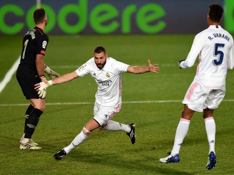 MADRID, SPAIN - DECEMBER 15: Karim Benzema of Real Madrid celebrates after scoring his sides second goal during the La Liga Santander match between Real Madrid and Athletic Club at Estadio Alfredo Di Stefano on December 15, 2020 in Madrid, Spain. Sporting stadiums around Spain remain under strict restrictions due to the Coronavirus Pandemic as Government social distancing laws prohibit fans inside venues resulting in games being played behind closed doors.  (Photo by Denis Doyle/Getty Images)
