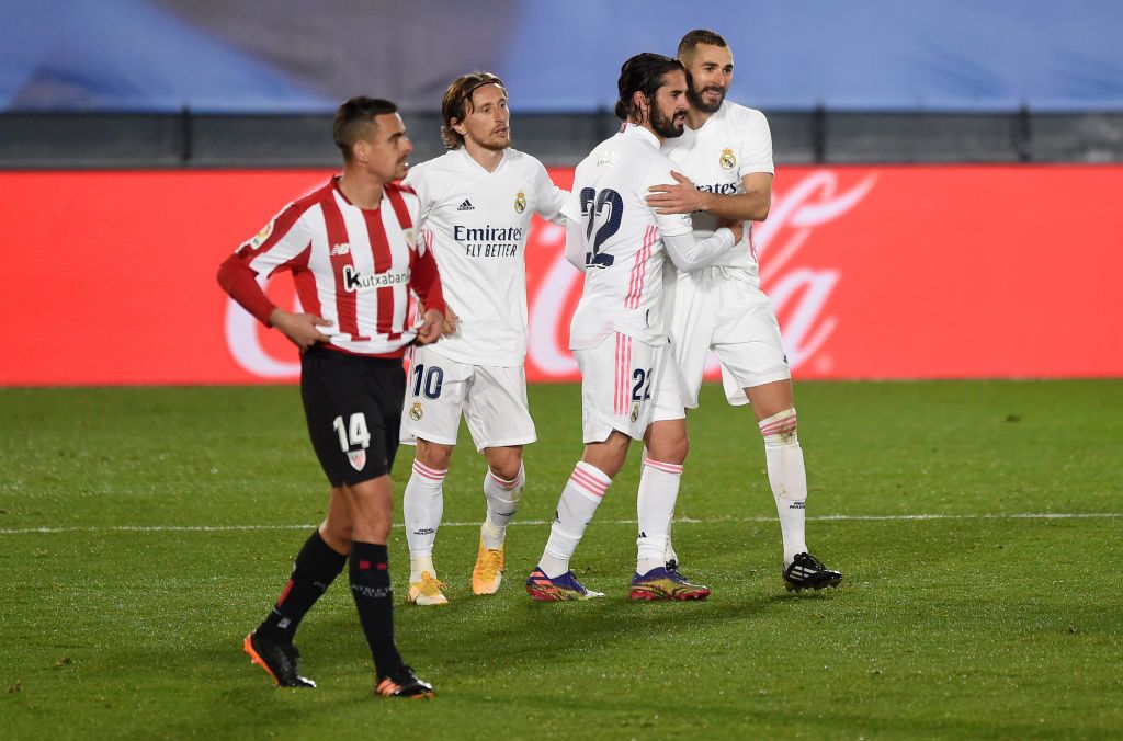MADRID, SPAIN - DECEMBER 15: Karim Benzema of Real Madrid celebrates with Luka Modric and Isco after scoring his sides third goal as Dani Garcia of Athletic Bilbao reacts during the La Liga Santander match between Real Madrid and Athletic Club at Estadio Alfredo Di Stefano on December 15, 2020 in Madrid, Spain. Sporting stadiums around Spain remain under strict restrictions due to the Coronavirus Pandemic as Government social distancing laws prohibit fans inside venues resulting in games being played behind closed doors.  (Photo by Denis Doyle/Getty Images)