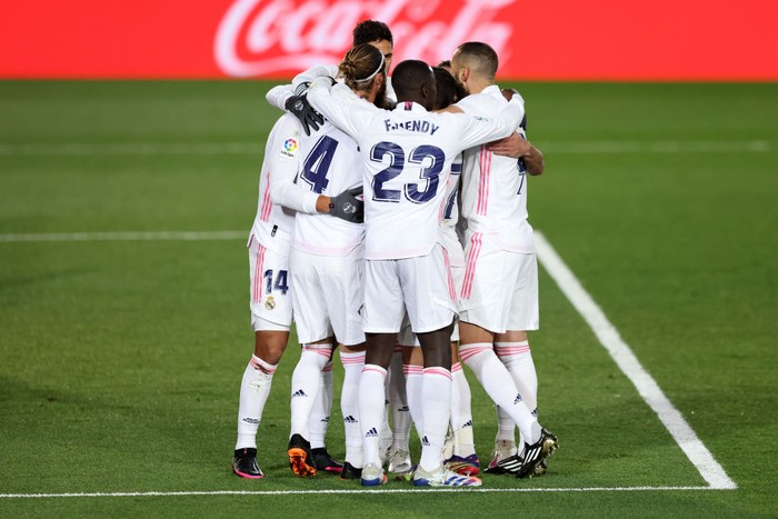 MADRID, SPAIN - DECEMBER 12: Casemiro of Real Madrid (obscured) celebrates with teammates Sergio Ramos, Vinicius Junior and Lucas Vazquez after scoring their sides first goal during the La Liga Santander match between Real Madrid and Atletico de Madrid at Estadio Alfedo Di Stefano on December 12, 2020 in Madrid, Spain. Sporting stadiums around Spain remain under strict restrictions due to the Coronavirus Pandemic as Government social distancing laws prohibit fans inside venues resulting in games being played behind closed doors. (Photo by Angel Martinez/Getty Images)