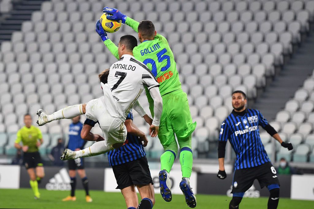 TURIN, ITALY - DECEMBER 16:  Cristiano Ronaldo (L) of Juventus clashes with Pierluigi Gollini of Atalanta BC during the Serie A match between Juventus and Atalanta BC at Allianz Stadium on December 16, 2020 in Turin, Italy.  (Photo by Valerio Pennicino/Getty Images)