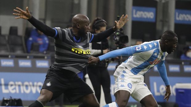 Napoli's Kalidou Koulibaly, right, dribbles past Inter Milan's Romelu Lukaku, left, during a Serie A soccer match between Inter Milan and Napoli, at the San Siro stadium in Milan, Italy, Wednesday, Dec.16, 2020. (AP Photo/Luca Bruno)