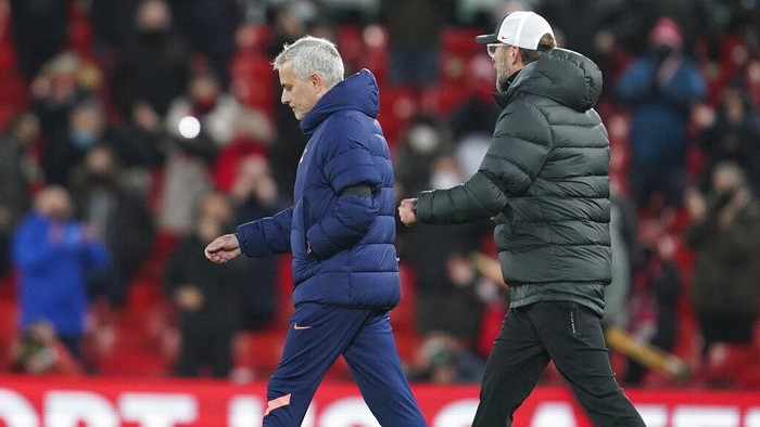 Tottenhams manager Jose Mourinho, left and Liverpools manager Jurgen Klopp walks onto the pitch after the end of the English Premier League soccer match between Liverpool and Tottenham Hotspur at Anfield in Liverpool, England, Wednesday, Dec. 16, 2020. Liverpool won the game 2-1. (AP Photo/Jon Super)