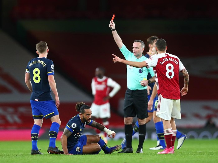 LONDON, ENGLAND - DECEMBER 16: Dani Ceballos of Arsenal reacts to match referee Paul Tierney who shows a red card to Gabriel of Arsenal (not pictured) during the Premier League match between Arsenal and Southampton at Emirates Stadium on December 16, 2020 in London, England. The match will be played without fans, behind closed doors as a Covid-19 precaution. (Photo by Clive Rose/Getty Images)
