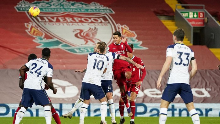 LIVERPOOL, ENGLAND - DECEMBER 16: Roberto Firmino of Liverpool scores their teams second goal during the Premier League match between Liverpool and Tottenham Hotspur at Anfield on December 16, 2020 in Liverpool, England. A limited number of fans (2000) are welcomed back to stadiums to watch elite football across England. This was following easing of restrictions on spectators in tiers one and two areas only. (Photo by Jon Super - Pool/Getty Images)