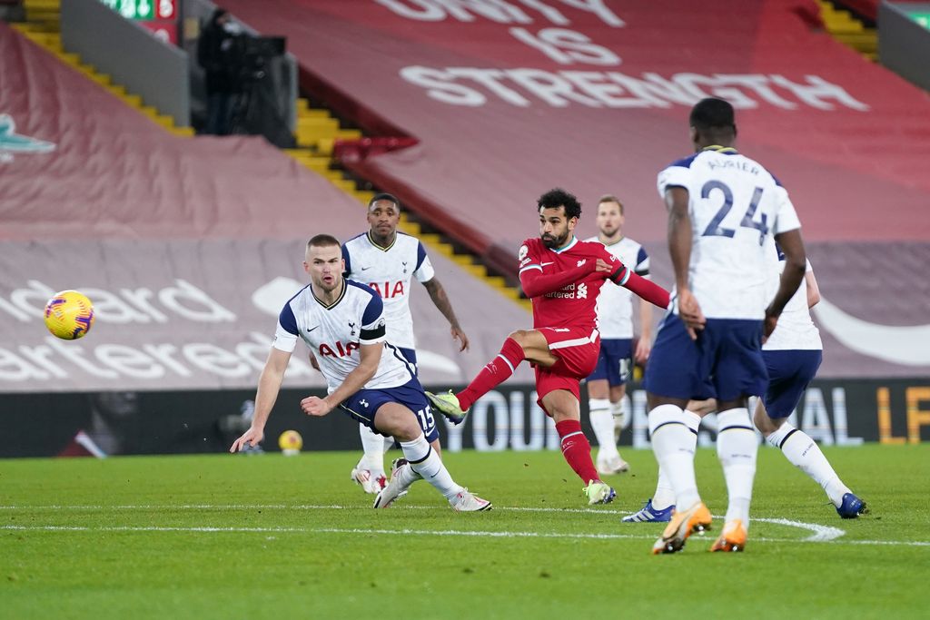 LIVERPOOL, ENGLAND - DECEMBER 16: Mohamed Salah of Liverpool shoots past Eric Dier of Tottenham Hotspur  during the Premier League match between Liverpool and Tottenham Hotspur at Anfield on December 16, 2020 in Liverpool, England. A limited number of fans (2000) are welcomed back to stadiums to watch elite football across England. This was following easing of restrictions on spectators in tiers one and two areas only. (Photo by Jon Super - Pool/Getty Images)