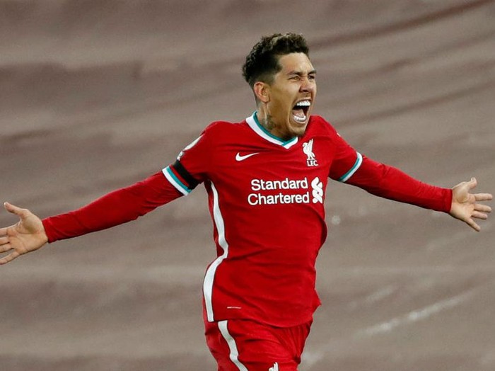 LIVERPOOL, ENGLAND - DECEMBER 16:Roberto Firmino of Liverpool celebrates after scoring their team's second goal during the Premier League match between Liverpool and Tottenham Hotspur at Anfield on December 16, 2020 in Liverpool, England. A limited number of fans (2000) are welcomed back to stadiums to watch elite football across England. This was following easing of restrictions on spectators in tiers one and two areas only. (Photo by Clive Brunskill/Getty Images)