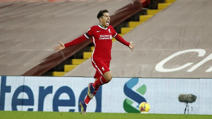 LIVERPOOL, ENGLAND - DECEMBER 16: Roberto Firmino of Liverpool celebrates after scoring their teams second goal  during the Premier League match between Liverpool and Tottenham Hotspur at Anfield on December 16, 2020 in Liverpool, England. A limited number of fans (2000) are welcomed back to stadiums to watch elite football across England. This was following easing of restrictions on spectators in tiers one and two areas only. (Photo by Clive Brunskill/Getty Images)