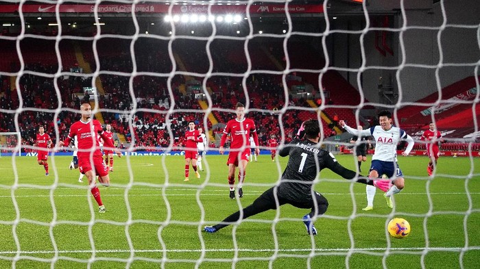 LIVERPOOL, ENGLAND - DECEMBER 16: Son Heung-Min of Tottenham Hotspur scores their teams first goal past Alisson Becker of Liverpool during the Premier League match between Liverpool and Tottenham Hotspur at Anfield on December 16, 2020 in Liverpool, England. A limited number of fans (2000) are welcomed back to stadiums to watch elite football across England. This was following easing of restrictions on spectators in tiers one and two areas only. (Photo by Jon Super - Pool/Getty Images)