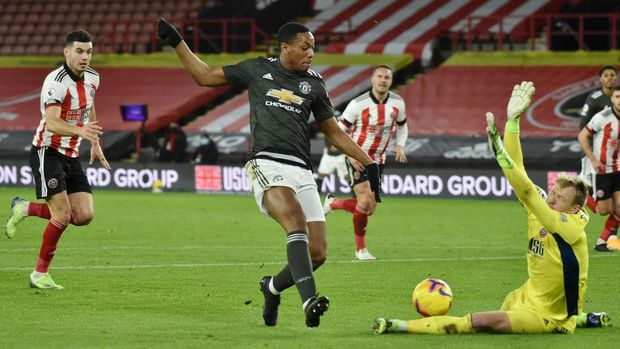 SHEFFIELD, ENGLAND - DECEMBER 17: Anthony Martial of Manchester United flips Aaron Ramsdale of Sheffield United before scoring the first goal for his sides during the Premier League match between Sheffield United and Manchester United at Bramall Lane on 17 December 2020 in Sheffield, England.  The match will be played without fans, behind closed doors as a Covid-19 precautionary measure.  (Photo by Rui Vieira - Pool / Getty Images)