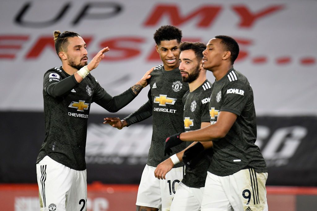 SHEFFIELD, ENGLAND - DECEMBER 17: Manchester United's Marcus Rashford celebrates with his teammates (l - r) Alex Telles, Bruno Fernandes and Anthony Martial after scoring their sides' third goal during the Premier League match between Sheffield United and Manchester United on Bramall Lane on December 17, 2020 in Sheffield, England.  The match will be played without fans, behind closed doors as a Covid-19 precautionary measure.  (Photo by Peter Powell - Pool / Getty Images)