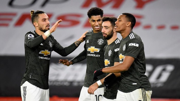 SHEFFIELD, ENGLAND - DECEMBER 17: Marcus Rashford of Manchester United celebrates with team mates (l - r) Alex Telles, Bruno Fernandes and Anthony Martial after scoring their sides third goal during the Premier League match between Sheffield United and Manchester United at Bramall Lane on December 17, 2020 in Sheffield, England. The match will be played without fans, behind closed doors as a Covid-19 precaution.  (Photo by Peter Powell - Pool/Getty Images)