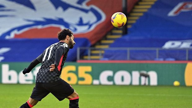 Liverpool's Mohamed Salah scores his side's sixth goal during the English Premier League soccer match between Crystal Palace and Liverpool at Selhurst Park stadium in London, Saturday, Dec. 19, 2020. (Justin Setterfield/Pool via AP)