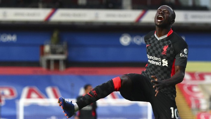Liverpools Sadio Mane celebrates after scoring his sides second goal during the English Premier League soccer match between Crystal Palace and Liverpool at Selhurst Park stadium in London, Saturday, Dec. 19, 2020. (Clive Rose/Pool via AP)