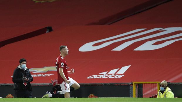 Manchester United's Scott McTominay celebrates his side's first goal during an English Premier League soccer match between Manchester United and Leeds United at the Old Trafford stadium in Manchester, England, Sunday Dec. 20, 2020. (Clive Brunskill/Pool via AP)