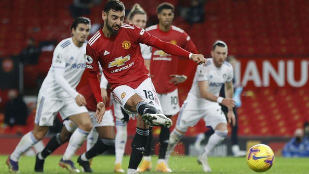 Manchester United's Bruno Fernandes scores his side's sixth goal from a penalty kick during an English Premier League soccer match between Manchester United and Leeds United at the Old Trafford stadium in Manchester, England, Sunday Dec. 20, 2020. (Clive Brunskill/Pool via AP)