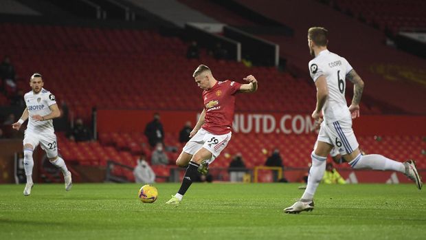 Manchester United's Scott McTominay shoots to score his side's opening goal during an English Premier League soccer match between Manchester United and Leeds United at the Old Trafford stadium in Manchester, England, Sunday Dec. 20, 2020. (Michael Regan/Pool via AP)