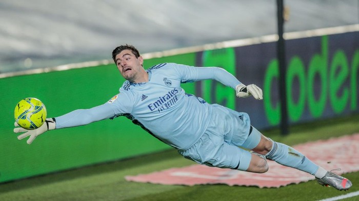 Real Madrids goalkeeper Thibaut Courtois stops a ball during the Spanish La Liga soccer match between Real Madrid and Athletic Club Bilbao at the Alfredo Di Stefano stadium in Madrid, Spain, Tuesday, Dec. 15, 2020. (AP Photo/Bernat Armangue)