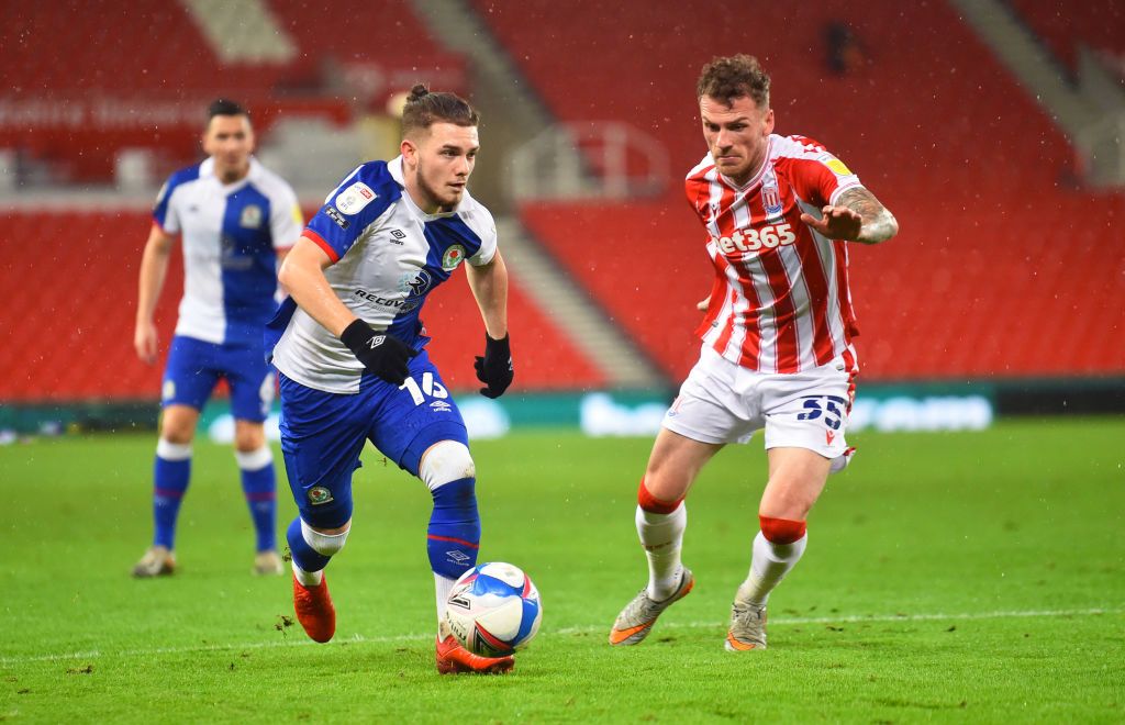 STOKE ON TRENT, ENGLAND - DECEMBER 19: Harvey Elliott of Blackburn runs past Josh Tymon of Blackburn during the Sky Bet Championship match between Stoke City and Blackburn Rovers at Bet365 Stadium on December 19, 2020 in Stoke on Trent, England. (Photo by Nathan Stirk/Getty Images)