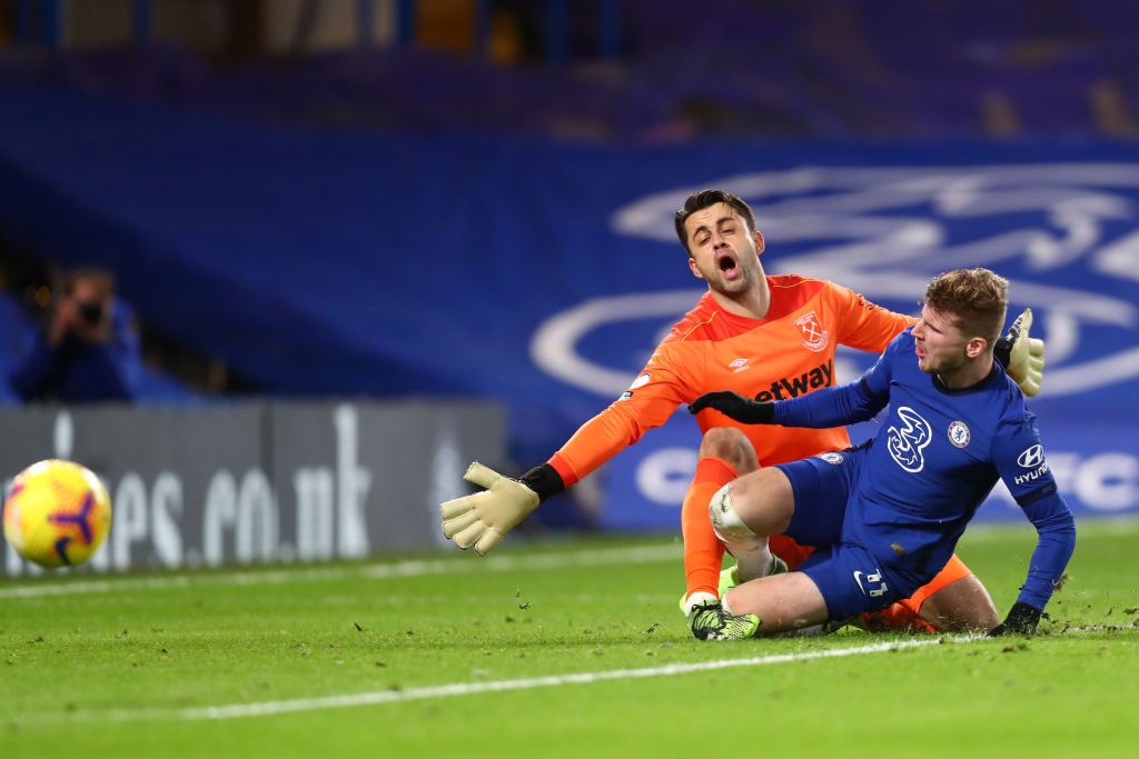 LONDON, ENGLAND - DECEMBER 21: Timo Werner of Chelsea collides with Lukasz Fabianski of West Ham United in the box during the Premier League match between Chelsea and West Ham United at Stamford Bridge on December 21, 2020 in London, England. The match will be played without fans, behind closed doors as a Covid-19 precaution. (Photo by Clive Rose/Getty Images)