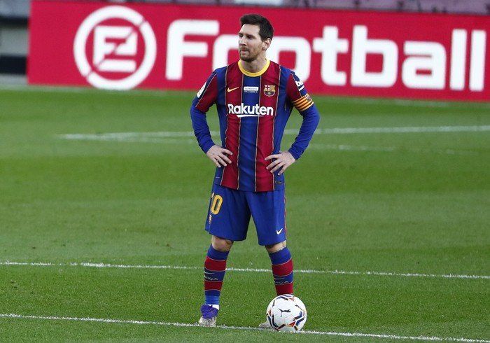 Barcelonas Lionel Messi waits in the centre circle to restart the match after Valencia scored the opening goal of the game during the Spanish La Liga soccer match between Barcelona and Valencia at the Camp Nou stadium in Barcelona, Spain, Saturday, Dec. 19, 2020. (AP Photo/Joan Monfort)