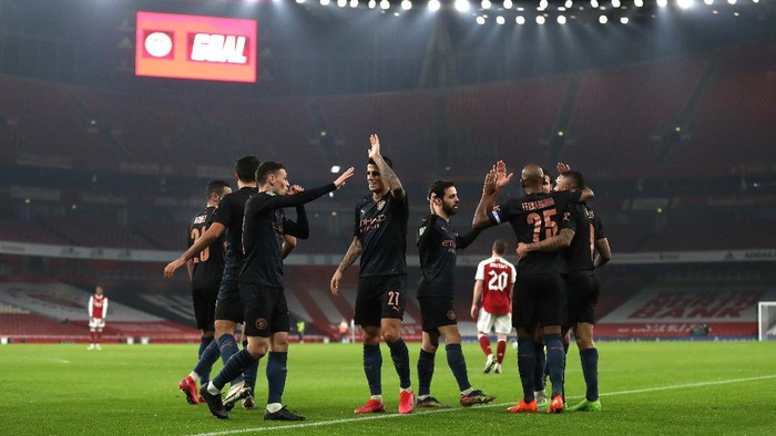LONDON, ENGLAND - DECEMBER 22: Phil Foden of Manchester City celebrates after scoring their sides third goal with teammate Joao Cancelo during the Carabao Cup Quarter Final match between Arsenal and Manchester City at Emirates Stadium on December 22, 2020 in London, England. The match will be played without fans, behind closed doors as a Covid-19 precaution. (Photo by Catherine Ivill/Getty Images)