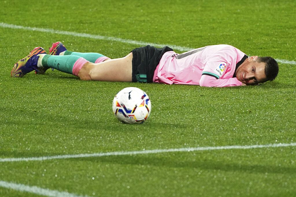 Barcelona's Lionel Messi lies on the ground during a Spanish La Liga soccer match between Valladolid and Barcelona at the Jose Zorrilla stadium in Valladolid, Spain,Tuesday Dec. 22, 2020. (Cesar Manso/Pool via AP)