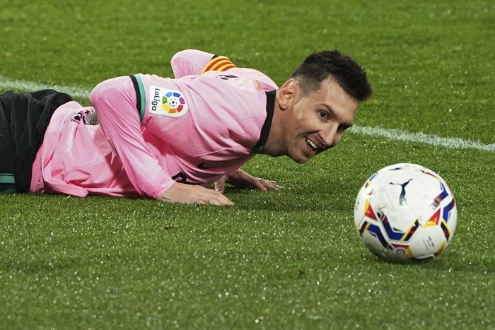 Barcelonas Lionel Messi lies on the ground during a Spanish La Liga soccer match between Valladolid and Barcelona at the Jose Zorrilla stadium in Valladolid, Spain,Tuesday Dec. 22, 2020. (Cesar Manso/Pool via AP)