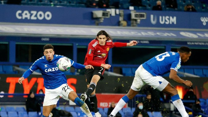 LIVERPOOL, ENGLAND - DECEMBER 23: Anthony Martial of Manchester United scores their teams second goal under pressure from Tom Davies of Everton during the Carabao Cup Quarter Final match between Everton and Manchester United at Goodison Park on December 23, 2020 in Liverpool, England.  A limited number of fans (2000) are welcomed back to stadiums to watch elite football across England. This was following easing of restrictions on spectators in tiers one and two areas only. (Photo by Clive Brunskill/Getty Images)