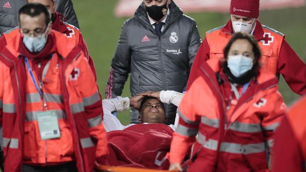 Real Madrid's Rodrygo is carried off the pitch with an injury during the Spanish La Liga soccer match between Real Madrid and Granada at the Alfredo Di Stefano stadium in Madrid, Spain, Wednesday, Dec. 23, 2020. (AP Photo/Bernat Armangue)