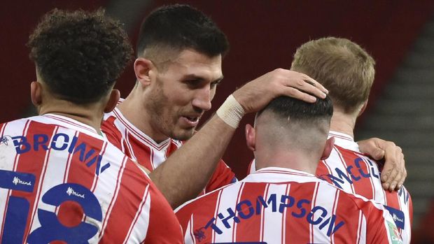 Stoke's Jordan Thompson, 3rd from left, celebrates with team mates after scoring his side's first goal during the English League Cup quarterfinal soccer match between Stoke City and Tottenham Hotspur at the Bet365 Stadium in Stoke on Trent, England, Wednesday Dec. 23, 2020. (AP Photo/Rui Vieira)