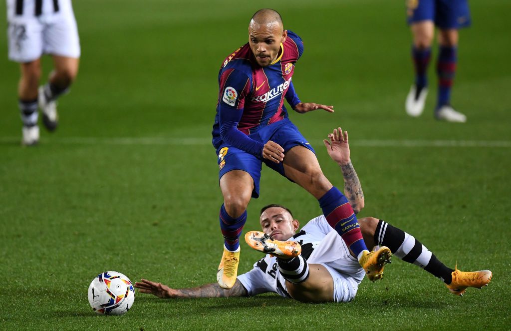 BARCELONA, SPAIN - DECEMBER 13: Martin Braithwaite of Barcelona is challenged by Roger of Levante during the La Liga Santander match between FC Barcelona and Levante UD at Camp Nou on December 13, 2020 in Barcelona, Spain. Sporting stadiums around Spain remain under strict restrictions due to the Coronavirus Pandemic as Government social distancing laws prohibit fans inside venues resulting in games being played behind closed doors. (Photo by David Ramos/Getty Images)