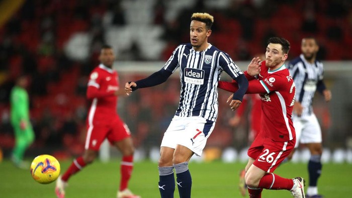 LIVERPOOL, ENGLAND - DECEMBER 27: Callum Robinson of West Bromwich Albion battles for possession with Andrew Robertson of Liverpool during the Premier League match between Liverpool and West Bromwich Albion at Anfield on December 27, 2020 in Liverpool, England. A limited number of fans (2000) are welcomed back to stadiums to watch elite football across England. This was following easing of restrictions on spectators in tiers one and two areas only. (Photo by Nick Potts - Pool/Getty Images)