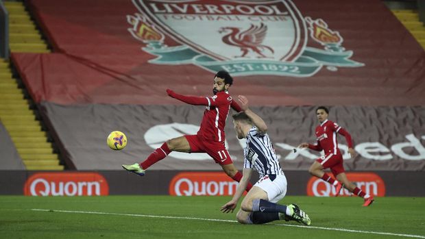 Liverpool's Mohamed Salah, tries a shot on goal during an English Premier League soccer match between Liverpool and West Bromwich Albion at the Anfield stadium in Liverpool, England, Sunday Dec. 27, 2020. (Nick Potts/Pool via AP)