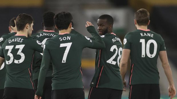Tottenham's Tanguy Ndombele, second right celebrates with teammates after scoring the opening goal of the game during the English Premier League soccer match between Wolverhampton Wanderers and Tottenham Hotspur at Molineux Stadium, in Woverhampton, England, Sunday, Dec. 27, 2020. (Carl Recine/ Pool via AP)