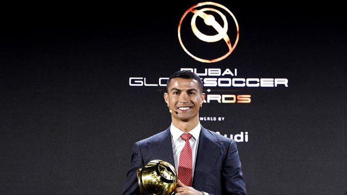 Cristiano Ronaldo Cristiano Ronaldo poses with the trophy of player of the century at the Dubai Globe Soccer Awards ceremony, in Dubai, United Arab Emirates, Sunday, Dec. 27, 2020. (Fabio Ferrari/LaPresse via AP)