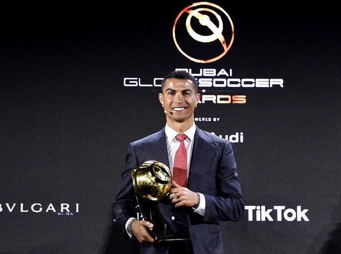 Cristiano Ronaldo poses with the trophy of player of the century at the Dubai Globe Soccer Awards ceremony, in Dubai, United Arab Emirates, Sunday, Dec. 27, 2020. (Fabio Ferrari/LaPresse via AP)